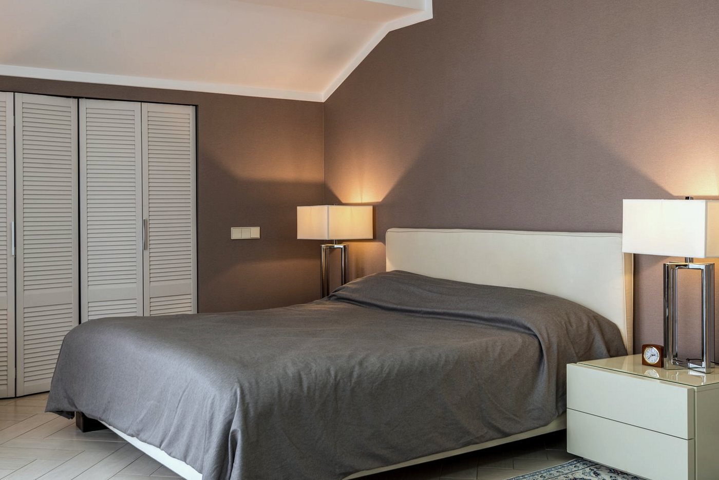 Bedroom with taupe painted walls and white woodwork